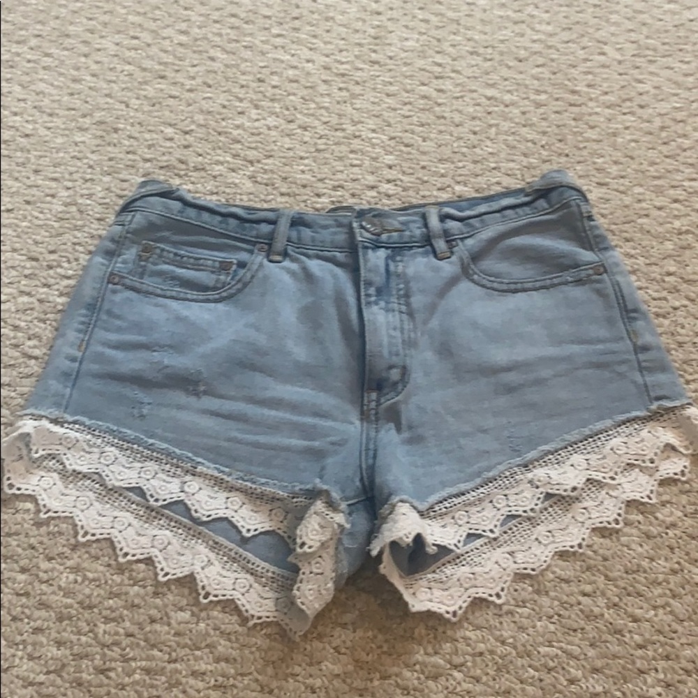 Free people denim shorts with lace detail